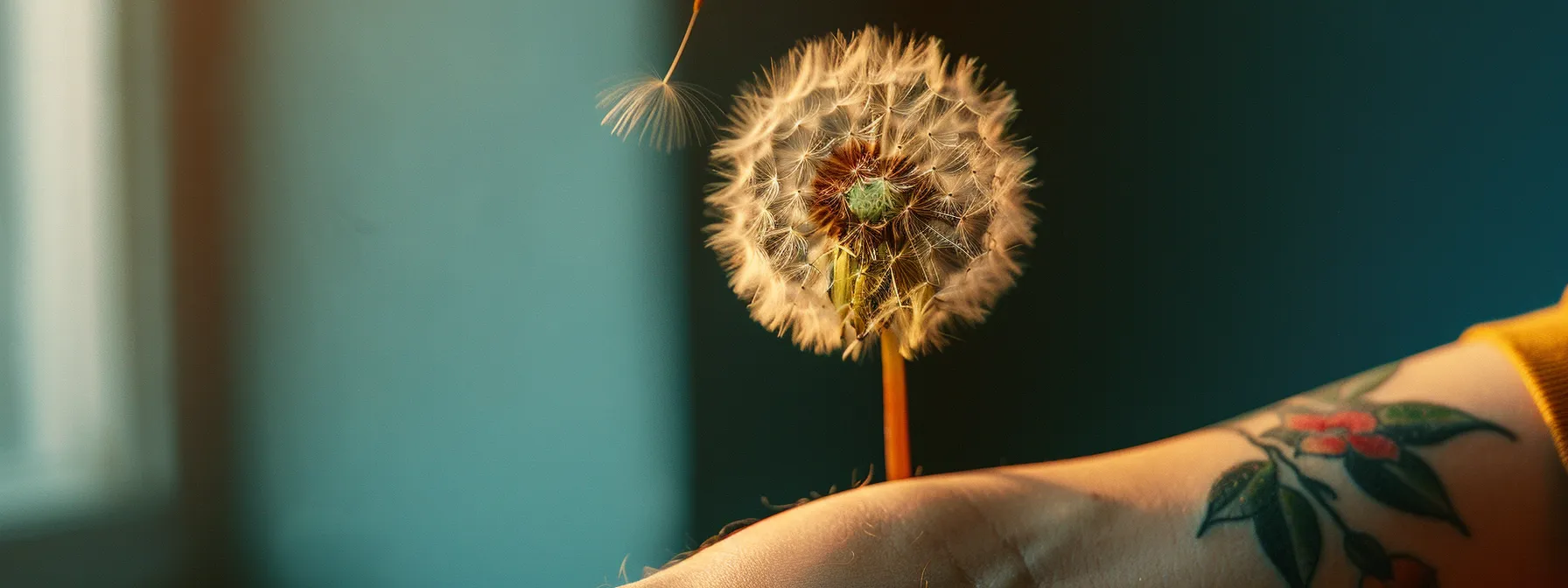 a close-up photo of a vibrant dandelion tattoo on someone's forearm, symbolizing luck and creativity.