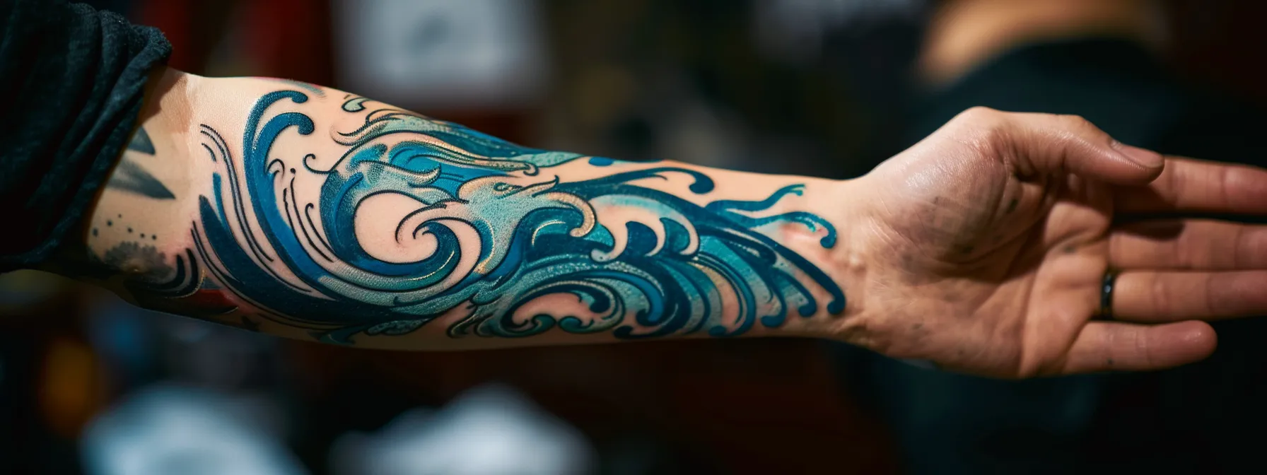 a mesmerizing ocean wave tattoo swirling with intricate blue and turquoise shades, symbolizing strength and fluidity.